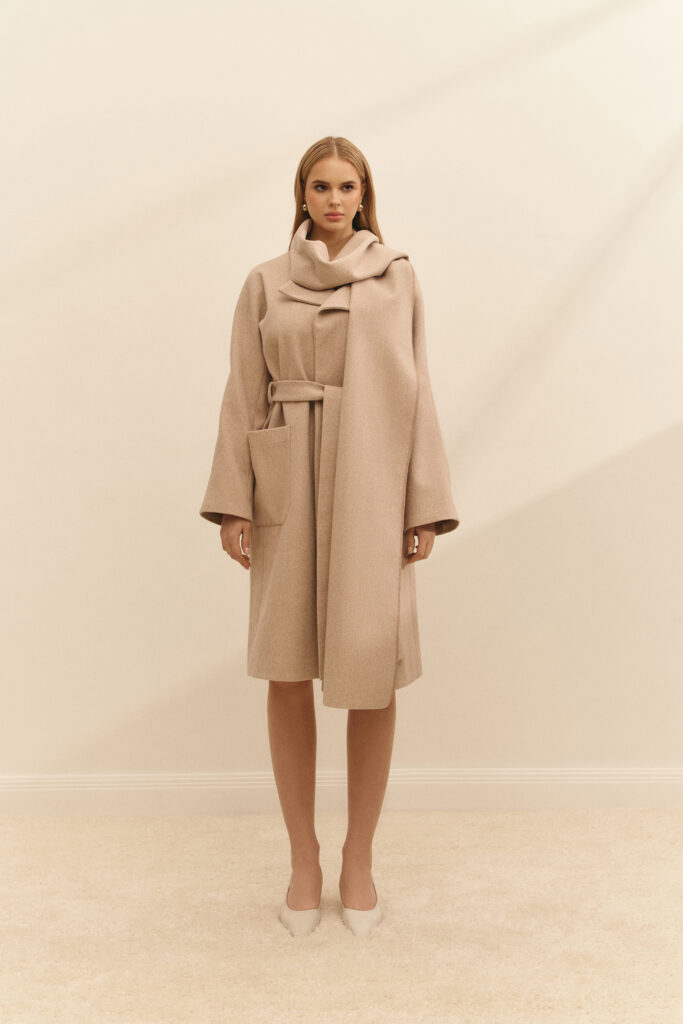 The coat with a scarf is white